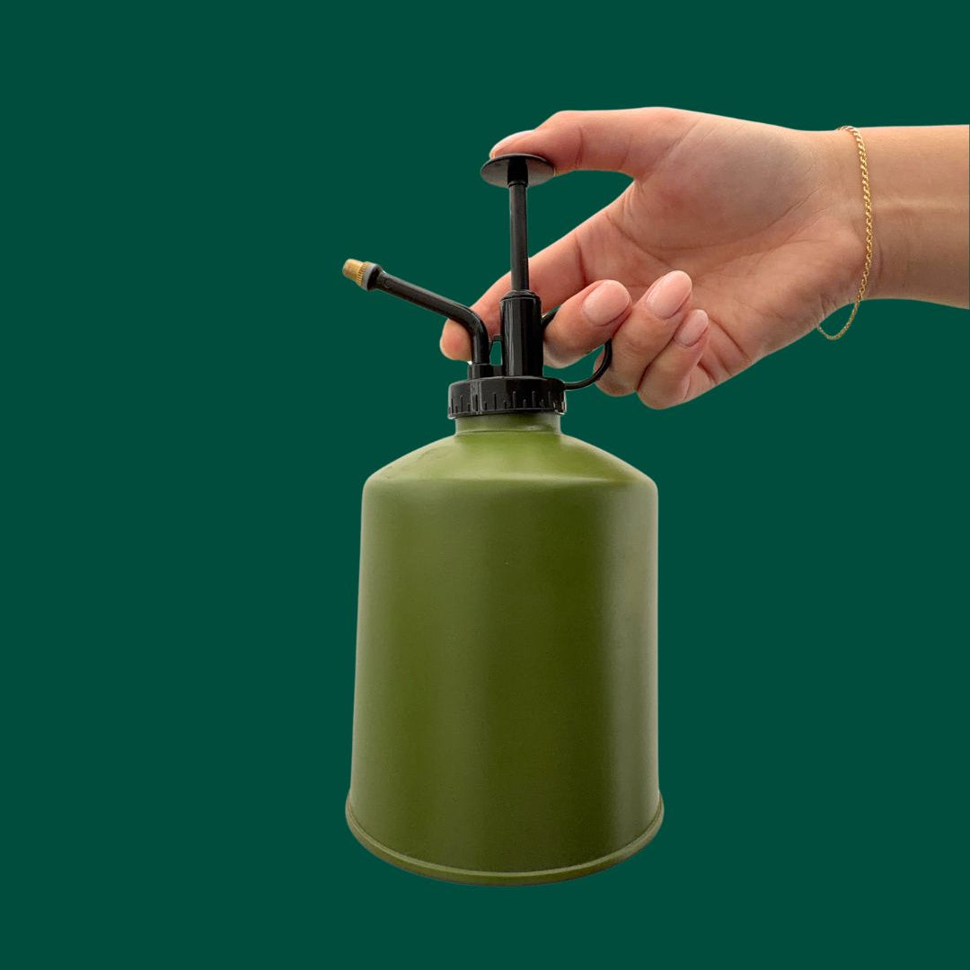 Hand holding the Bronte Plant Mister in the colour Avocado