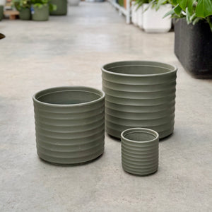 3 green planter pots with a ribbing texture running horizontally down the pot