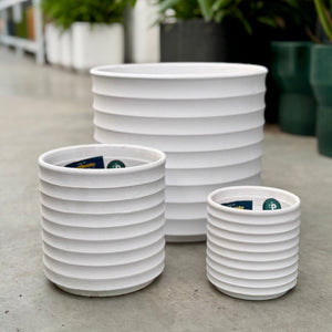3 White planter pots with a ribbing texture running horizontally down the pot